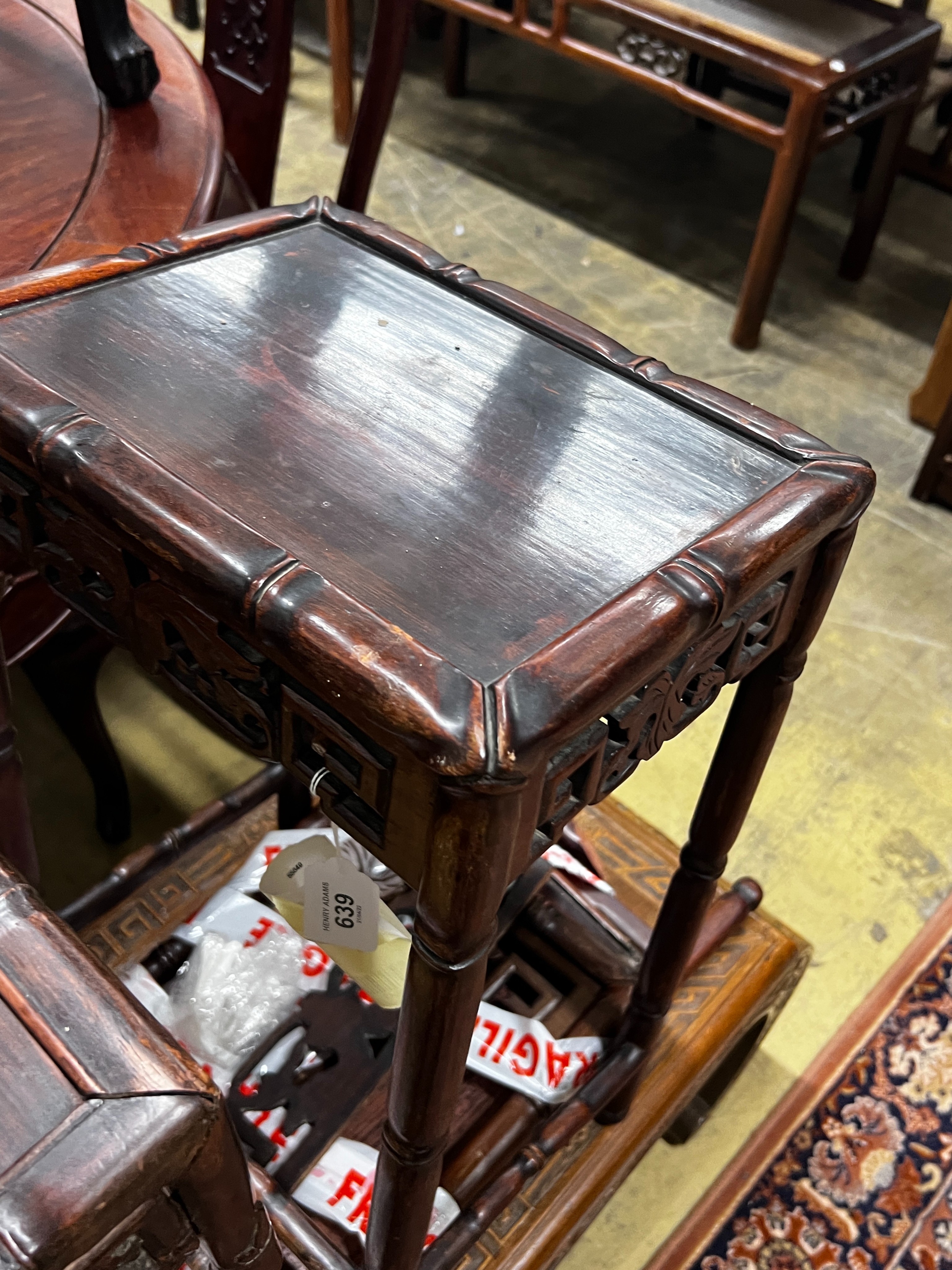 A Chinese carved hardwood low table, length 89cm, depth 43cm, height 36cm together with three Chinese carved hongmu occasional tables (one in need of extensive repair)